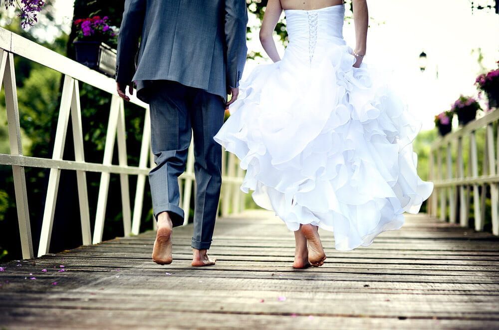 Bride and Groom Walking Barefoot on a Wooden Bridge — Coastal Vibez In Sydney, NSW