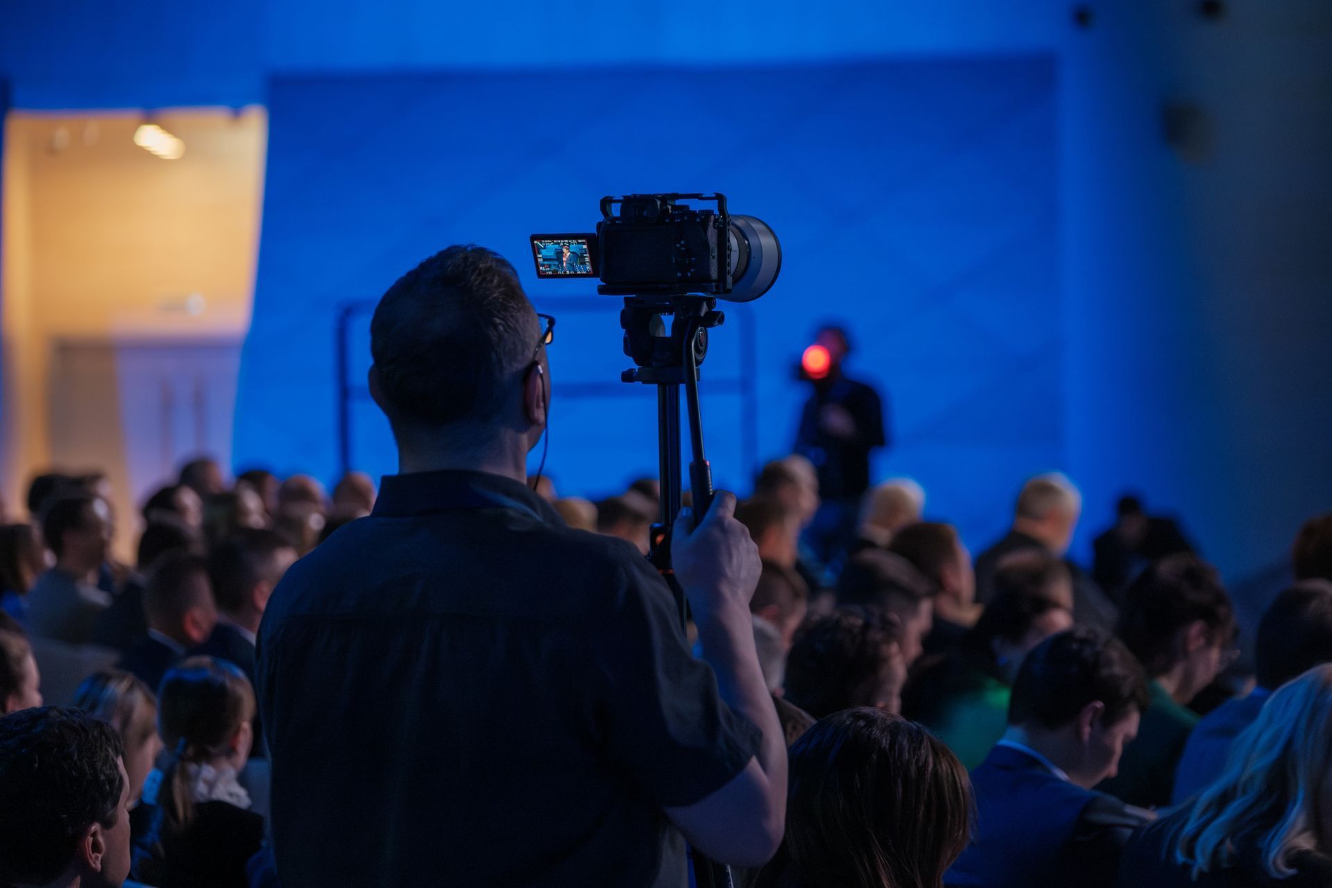 Videographer Films an Event From the Back of an Audience Blue-lit Stage — Coastal Vibez In The Entrance, NSW