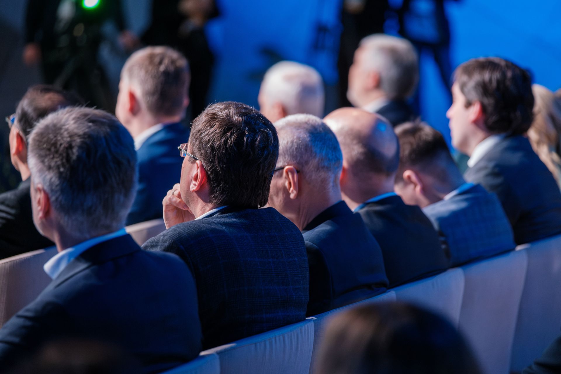 People in Suits Seated, Facing Forward in an Auditorium With Blue Lighting, Listening — Coastal Vibez In The Entrance, NSW