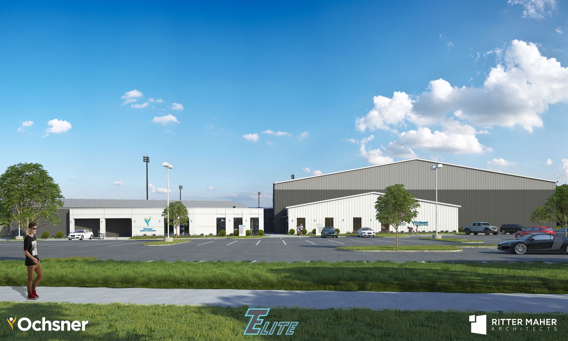 A man is walking down a sidewalk in front of a large building.