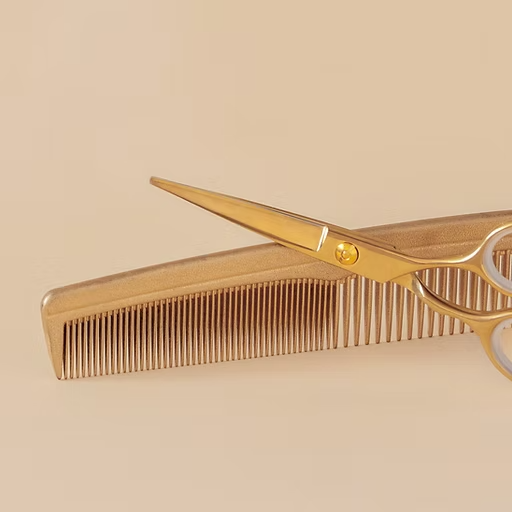 A pair of scissors laying on top of a comb