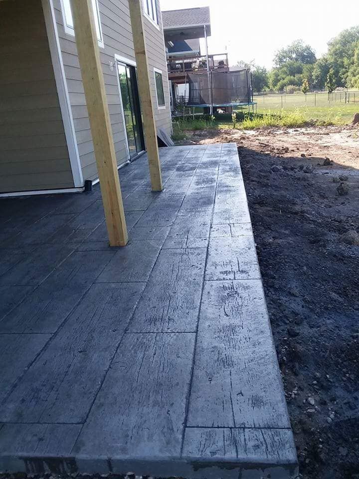 A concrete walkway is being built in front of a house.