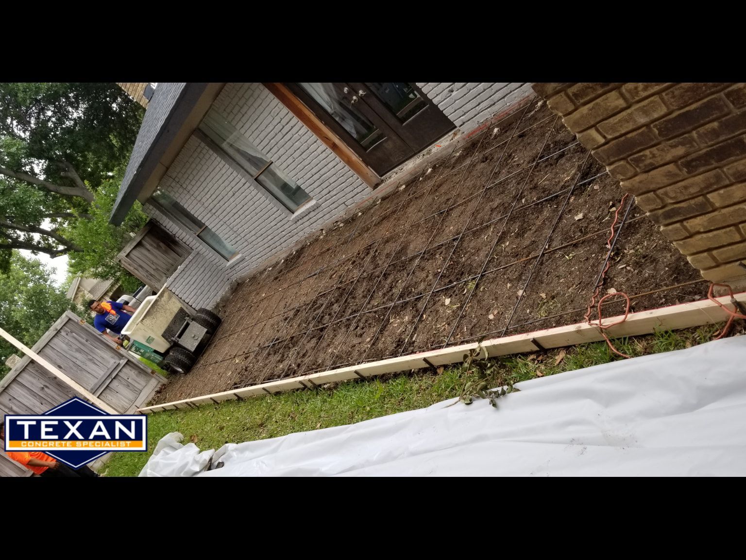 A brick house with a lot of dirt in front of it.