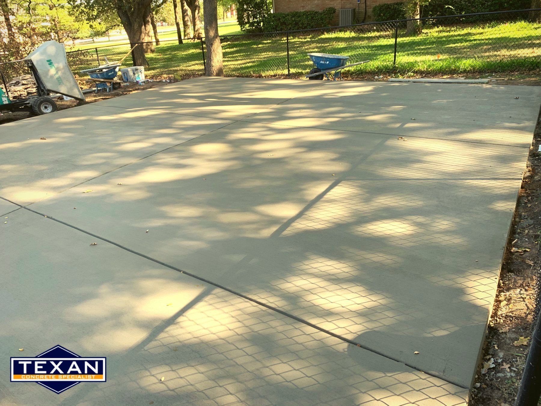 A concrete driveway with a texas logo on it