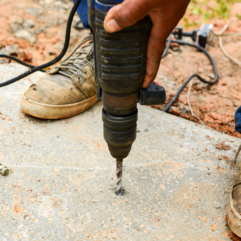 A concrete driveway with a texan logo on it