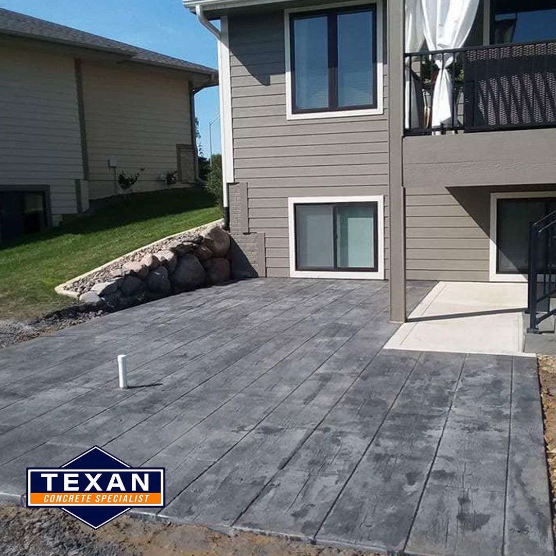 A house with a concrete patio in front of it.