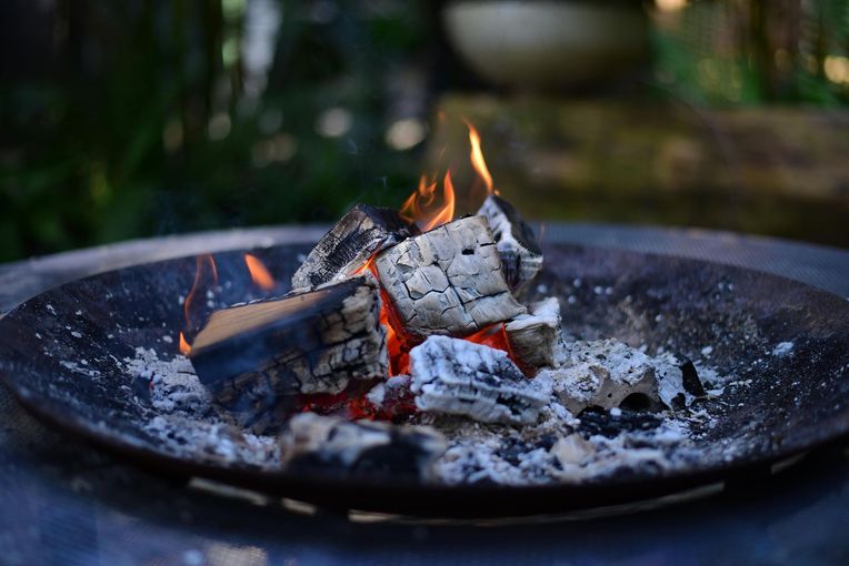 An aerial view of a large house with a fire pit in the backyard at dusk. - Sonia Immers, Top Realtor in Rocklin, CA