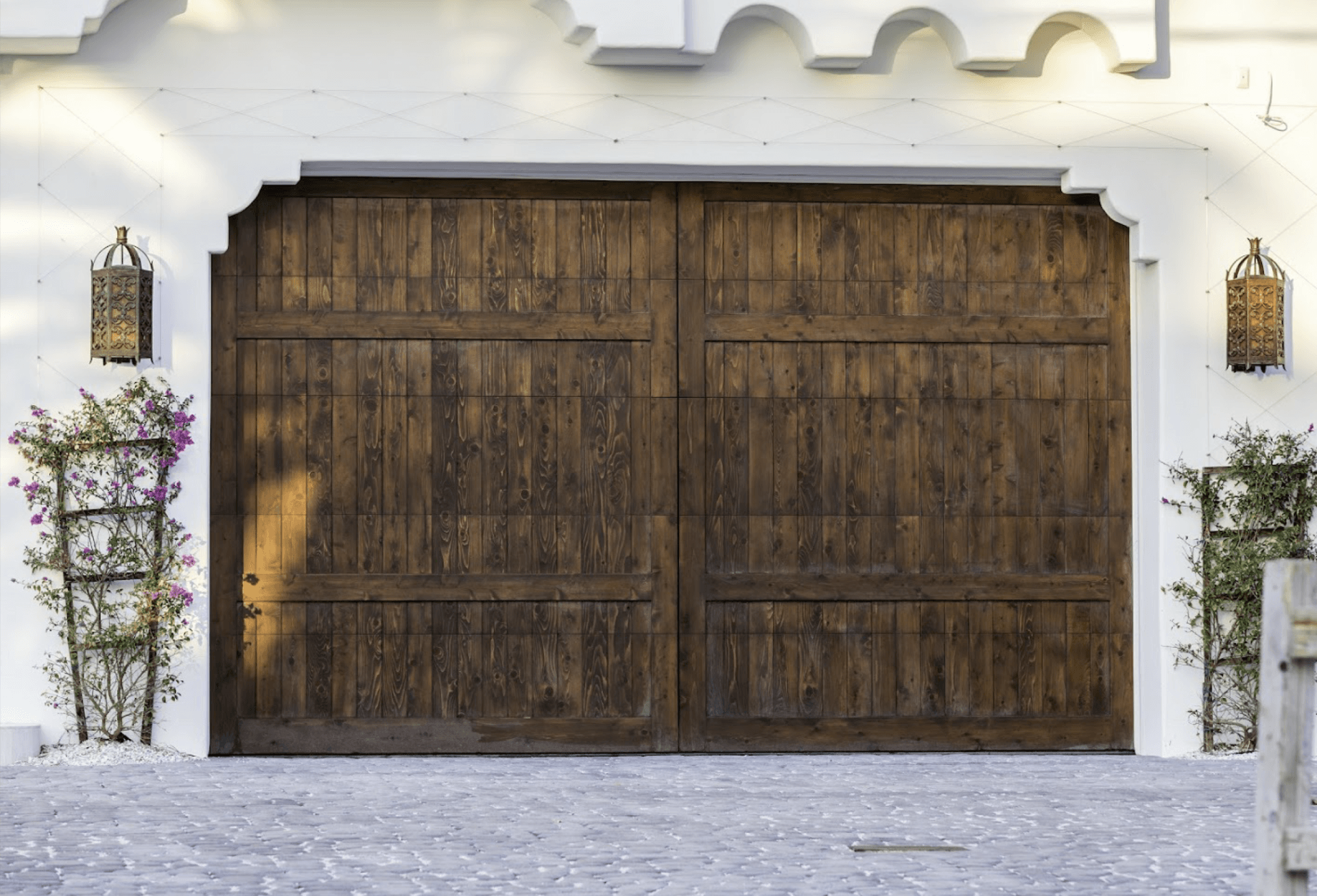 A Large Wooden Garage Door Is Sitting in Front of A White Building - Rochester Hills, MI - J & B Doors