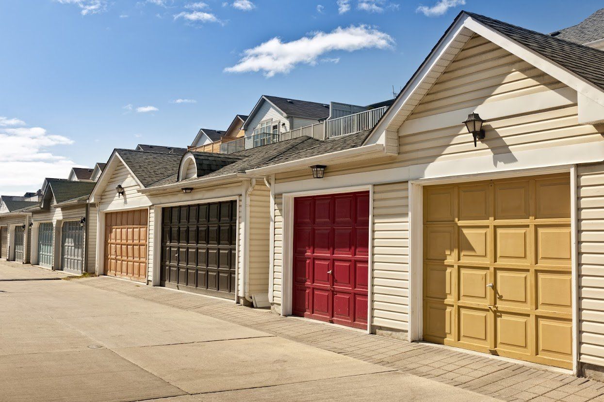 A Row of Garages with Different Colored Doors on A Sunny Day - Rochester Hills, MI - J & B Doors