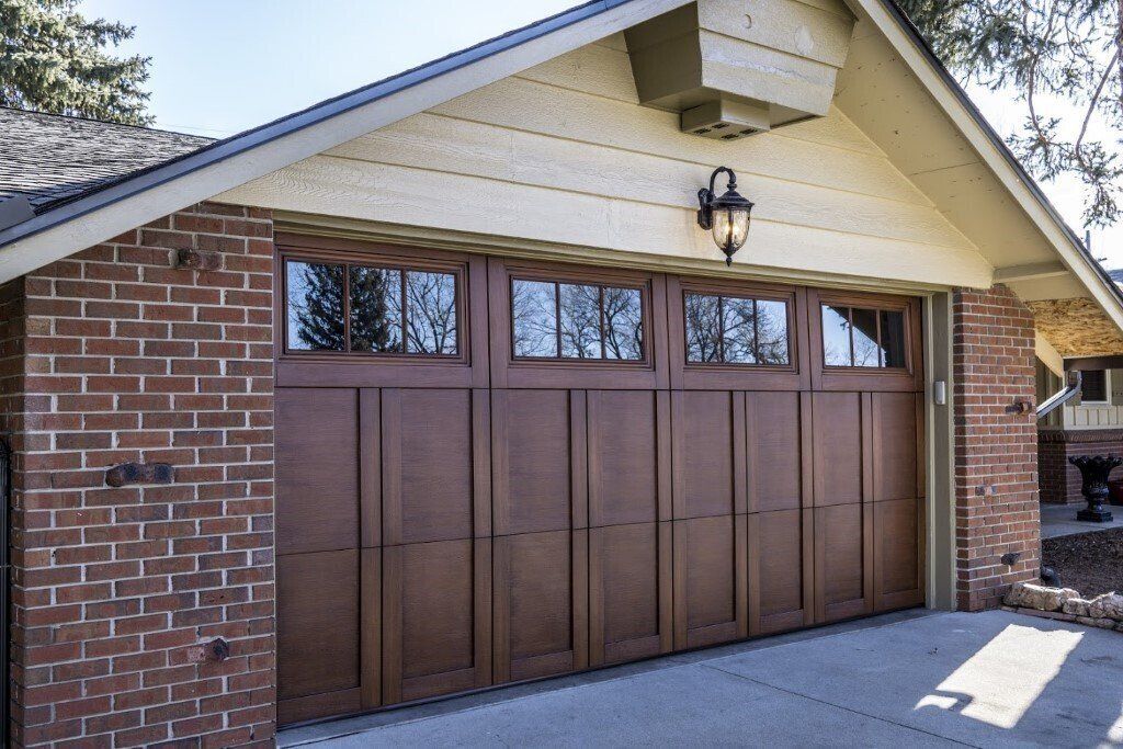 A Brick House with A Large Wooden Garage Door - Rochester Hills, MI - J & B Doors