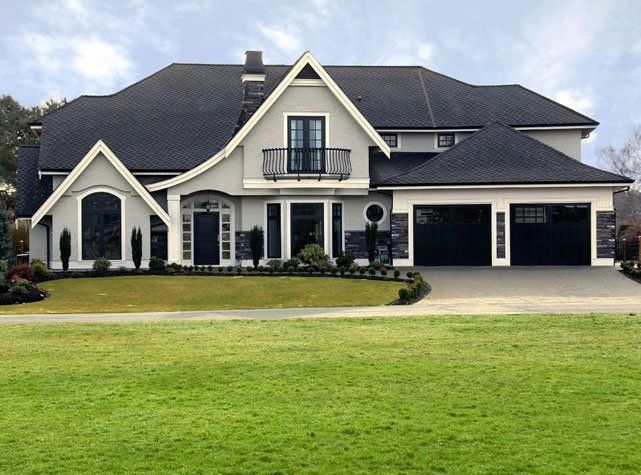 A Large White House with A Black Roof and Two Garages - Rochester Hills, MI - J & B Doors