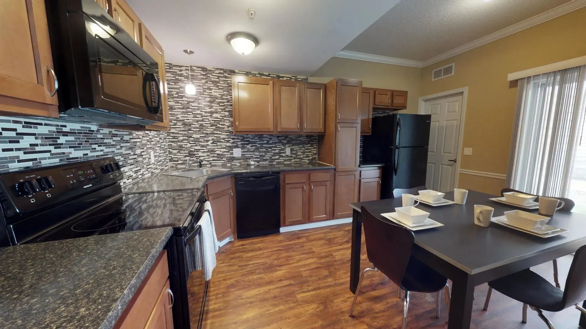 A kitchen with a table and chairs in it