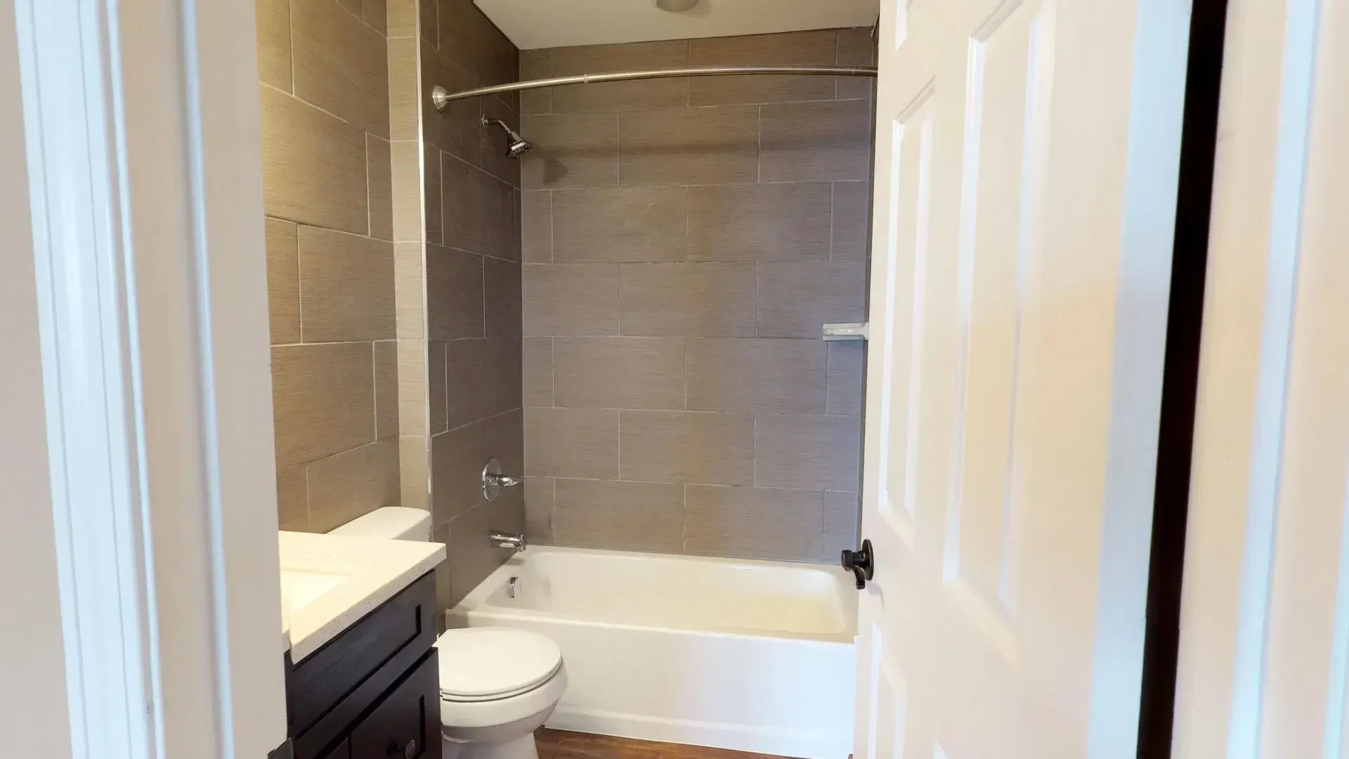 A bathroom with a toilet , sink , tub and shower.