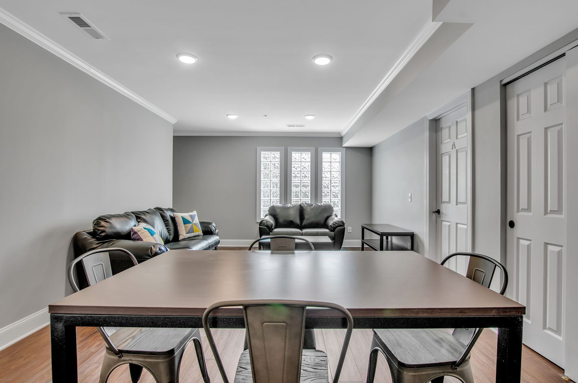 A living room with a table and chairs and a couch.