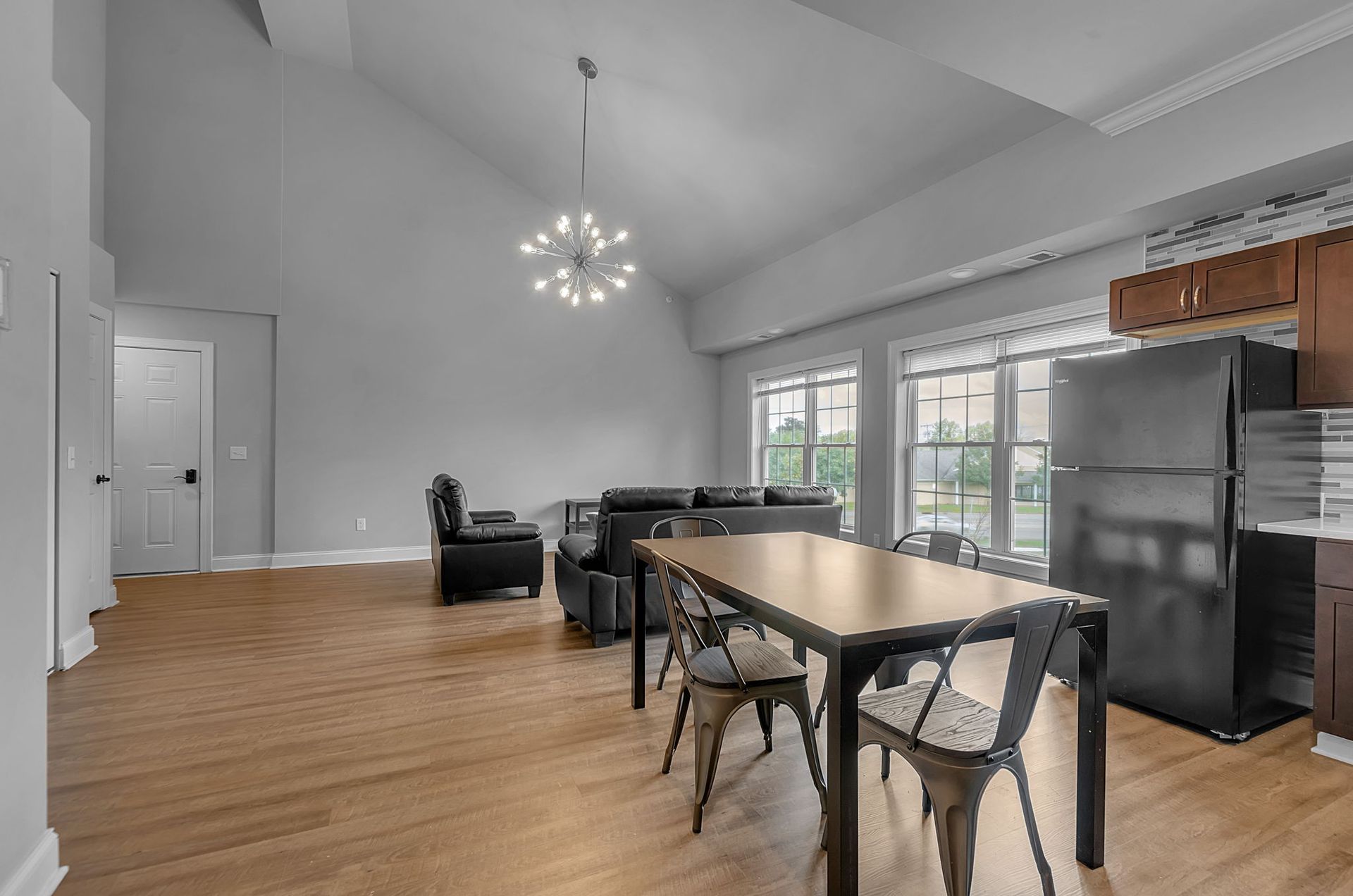 There is a table and chairs in the middle of the room.