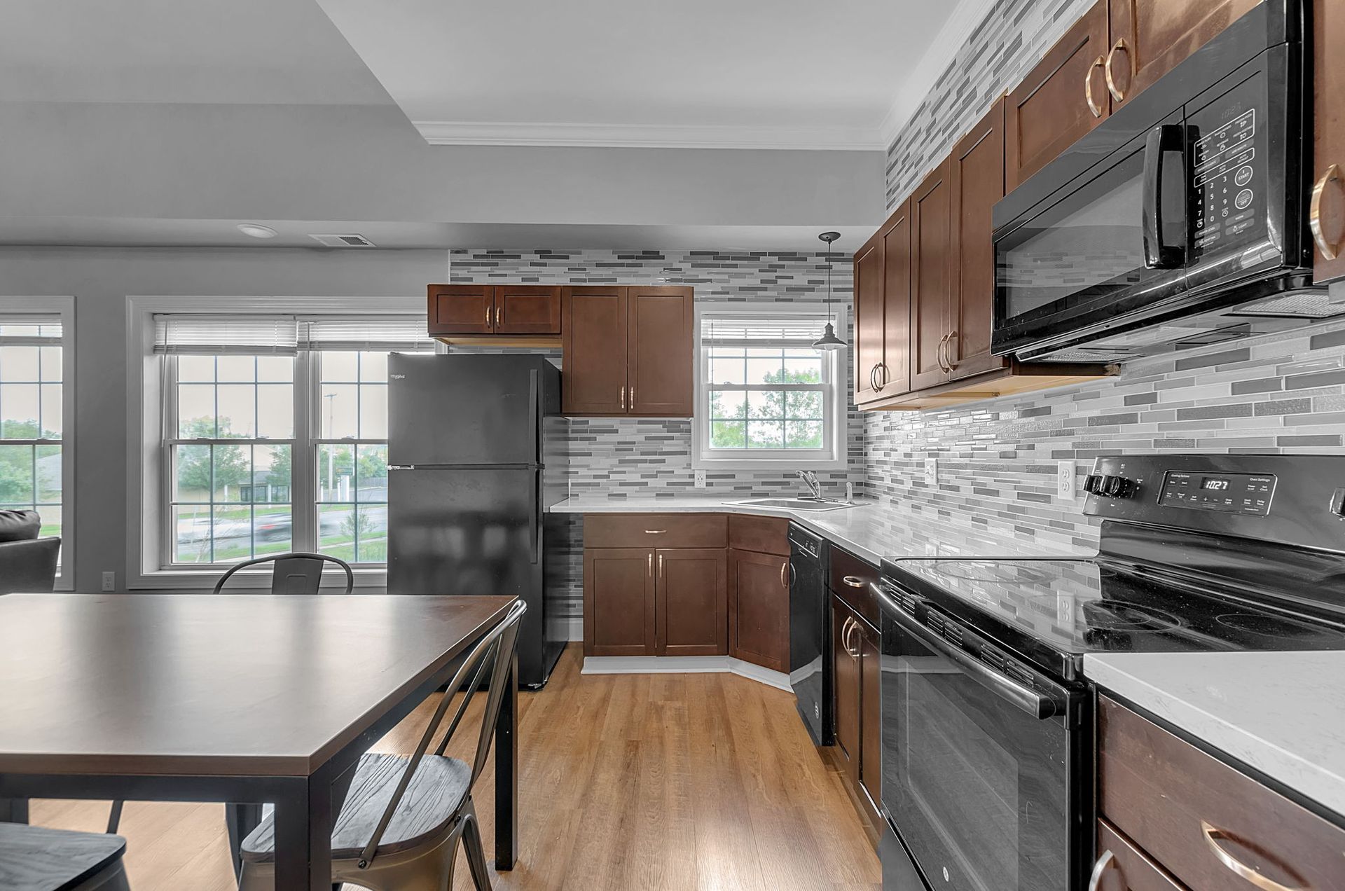A kitchen with stainless steel appliances and wooden cabinets