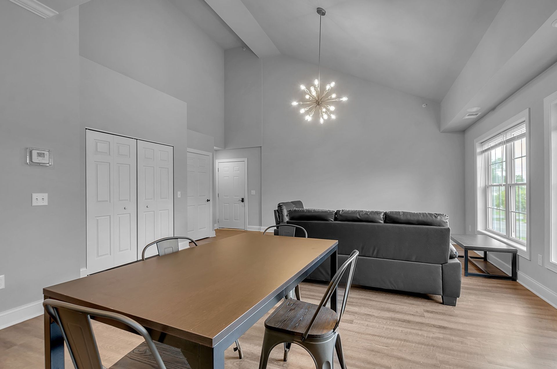 A living room with a table and chairs and a couch.