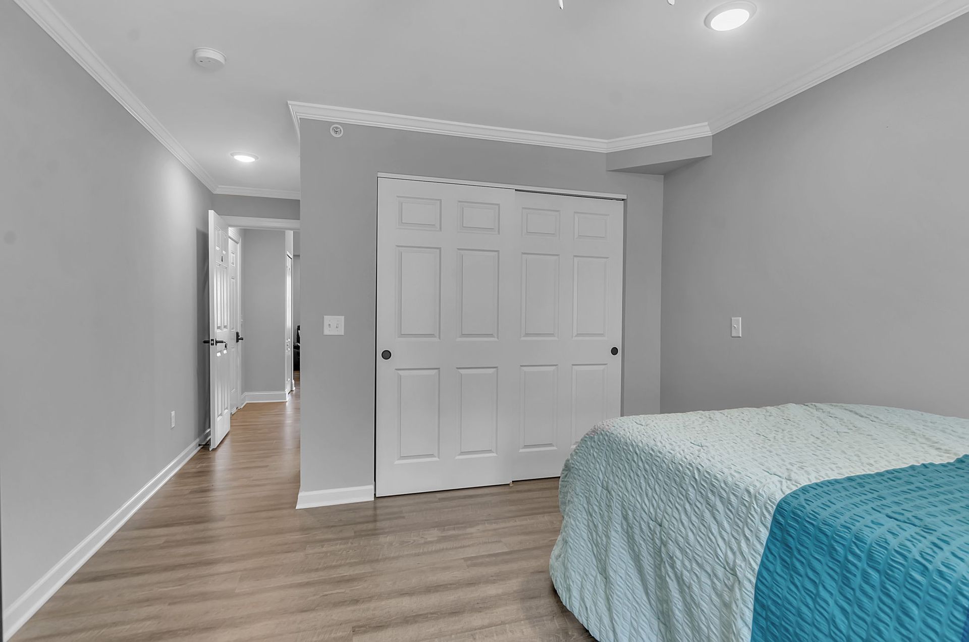 A bedroom with a bed and a closet.