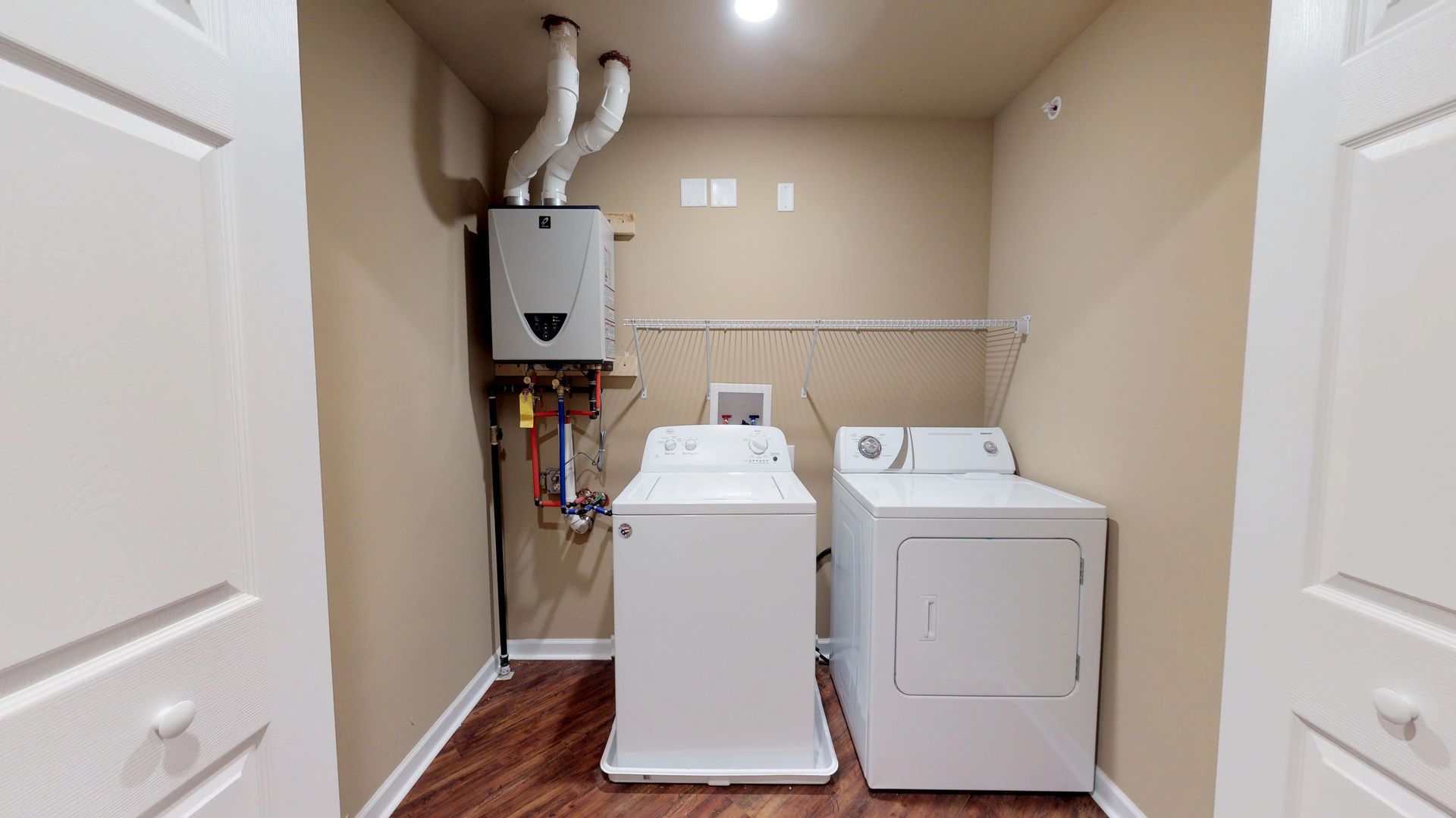 A laundry room with a washer and dryer in it.