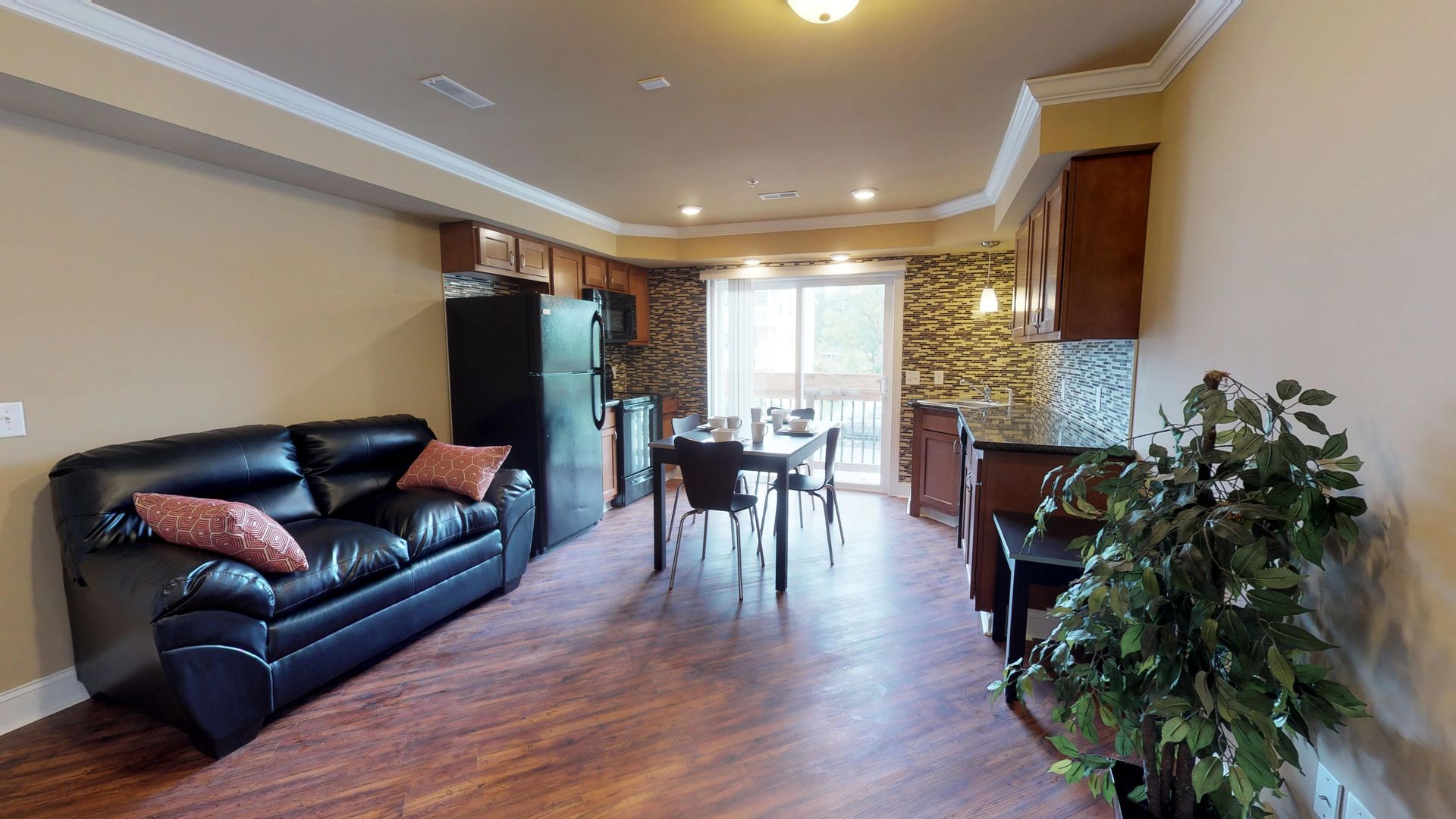 A living room with a couch , table and chairs.