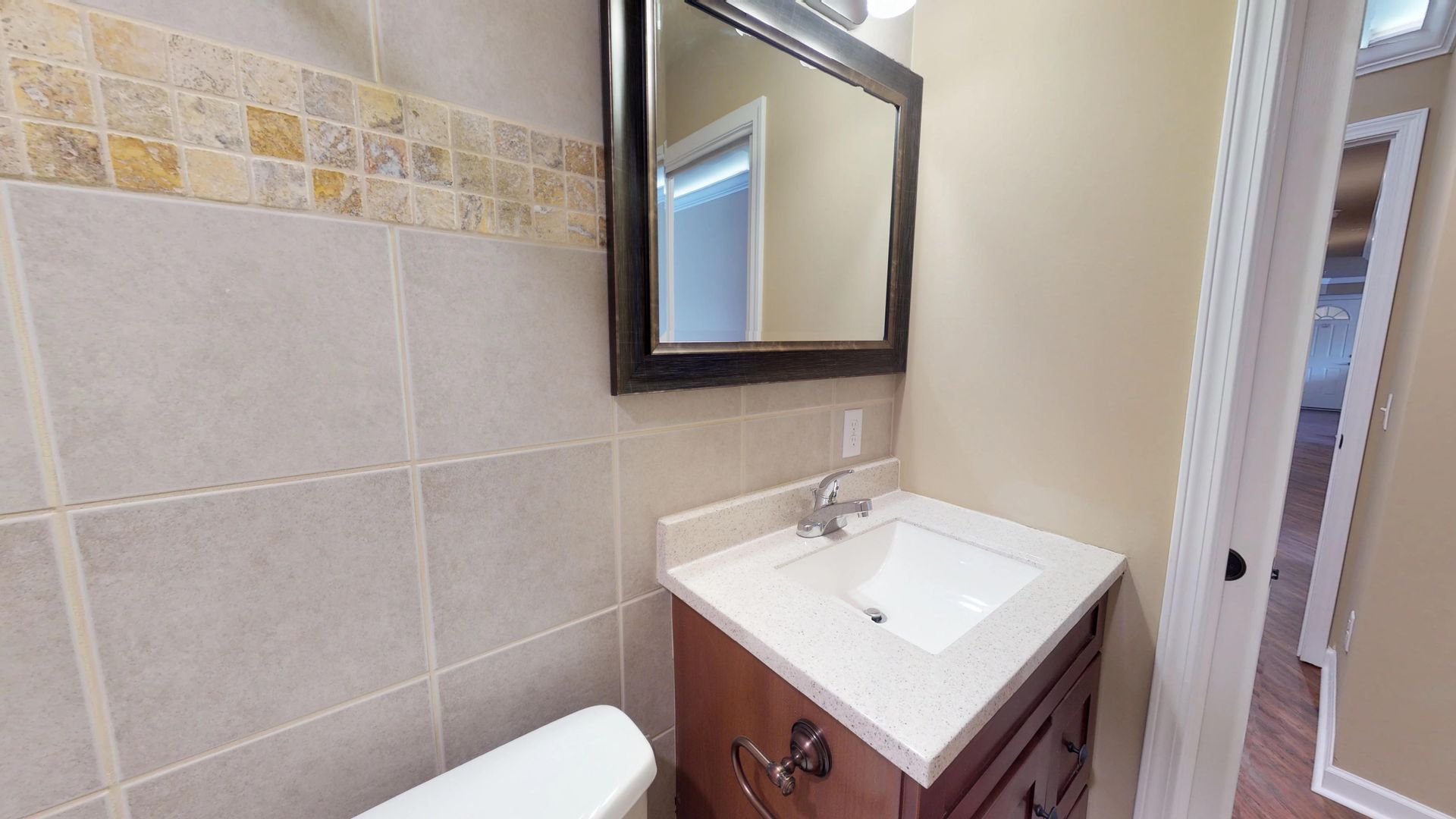 A bathroom with a sink , toilet and mirror.