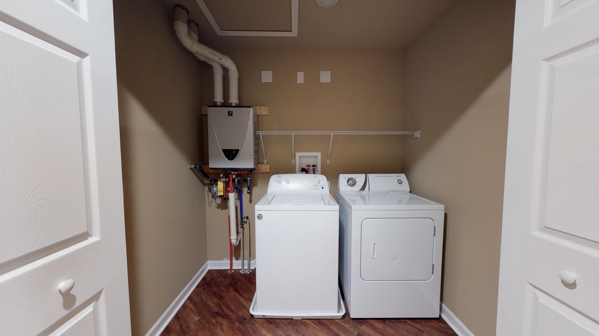 A laundry room with a washer and dryer in it.