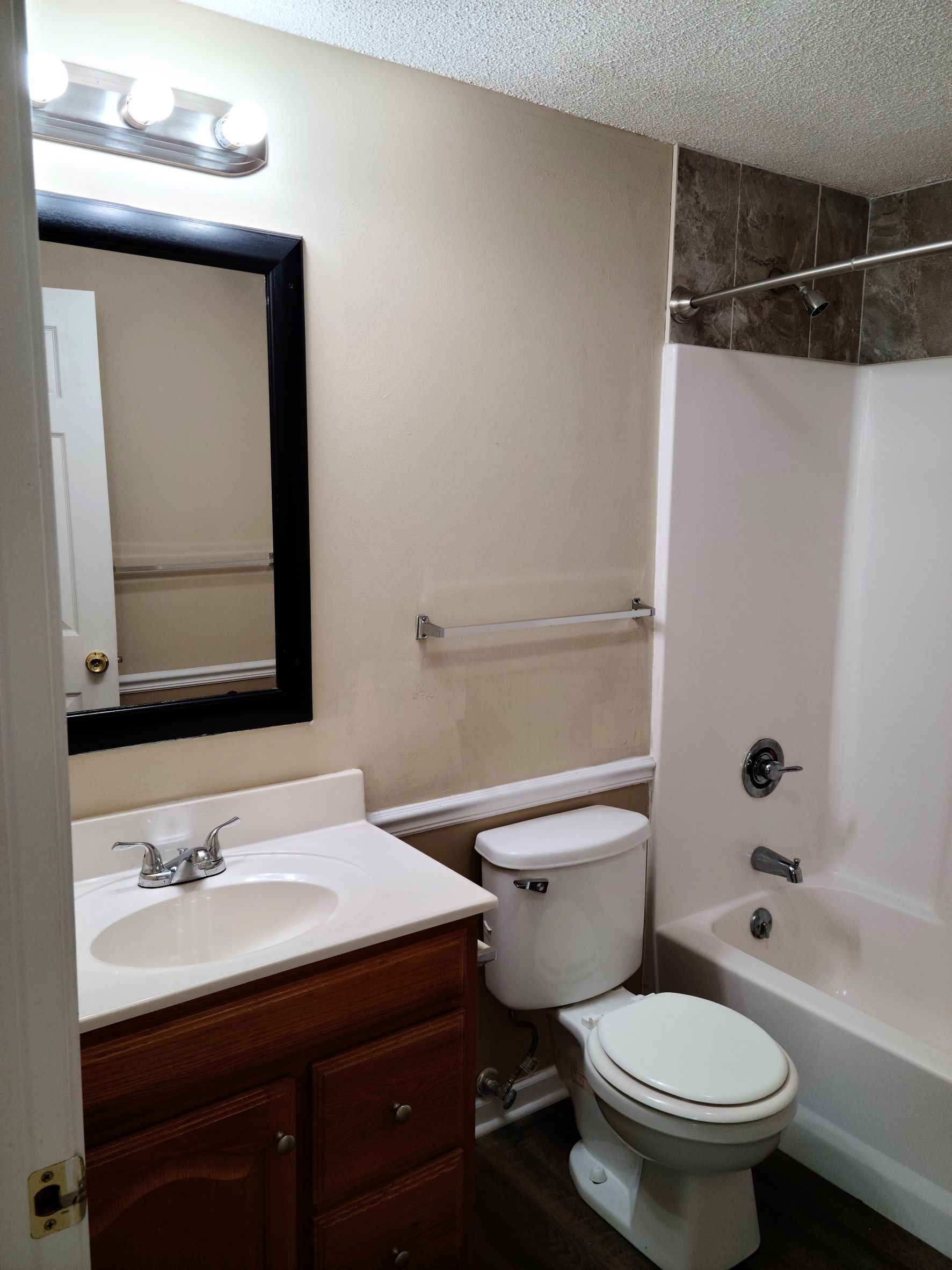 A bathroom with a toilet , sink and bathtub