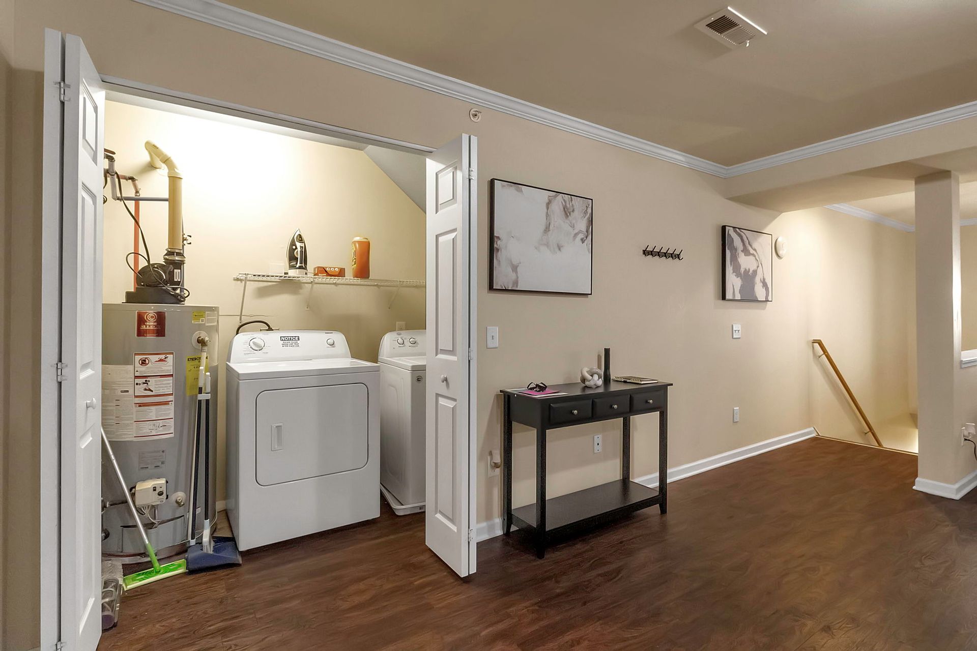 A laundry room with a washer and dryer and a table.