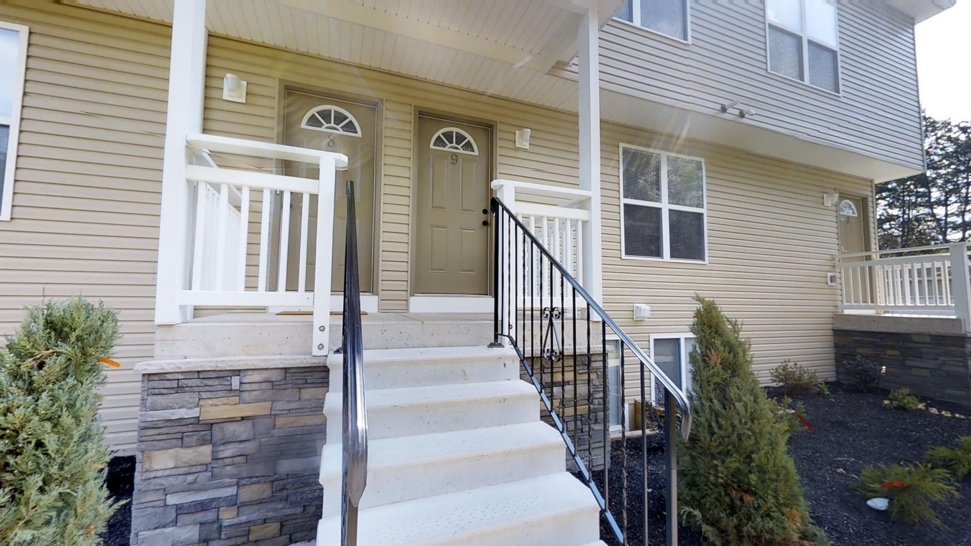A house with stairs leading up to the front door