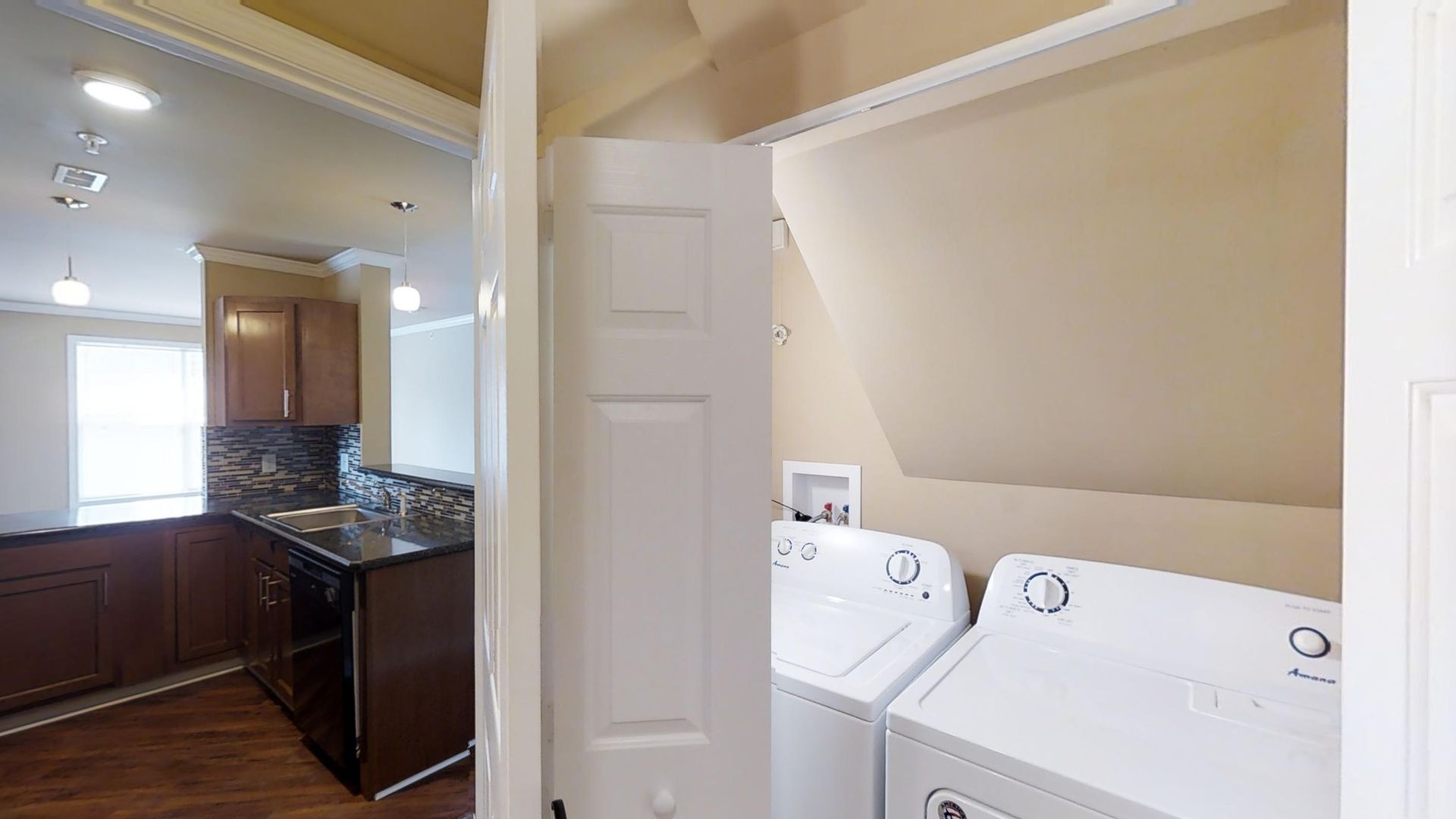 A laundry room with a washer and dryer in a house.