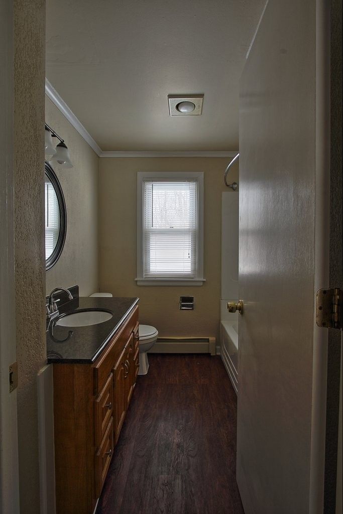 A bathroom with a sink , toilet , and bathtub.