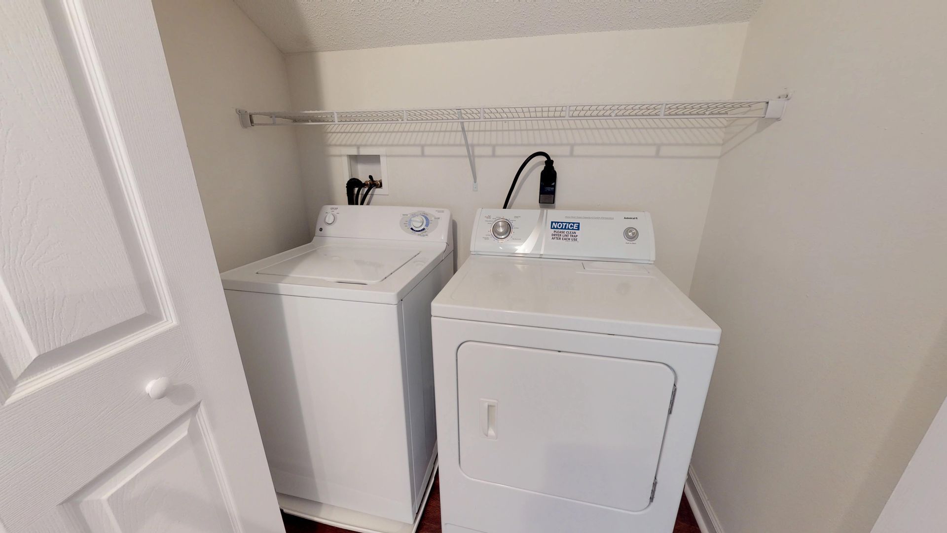 A laundry room with a washer and dryer in it.