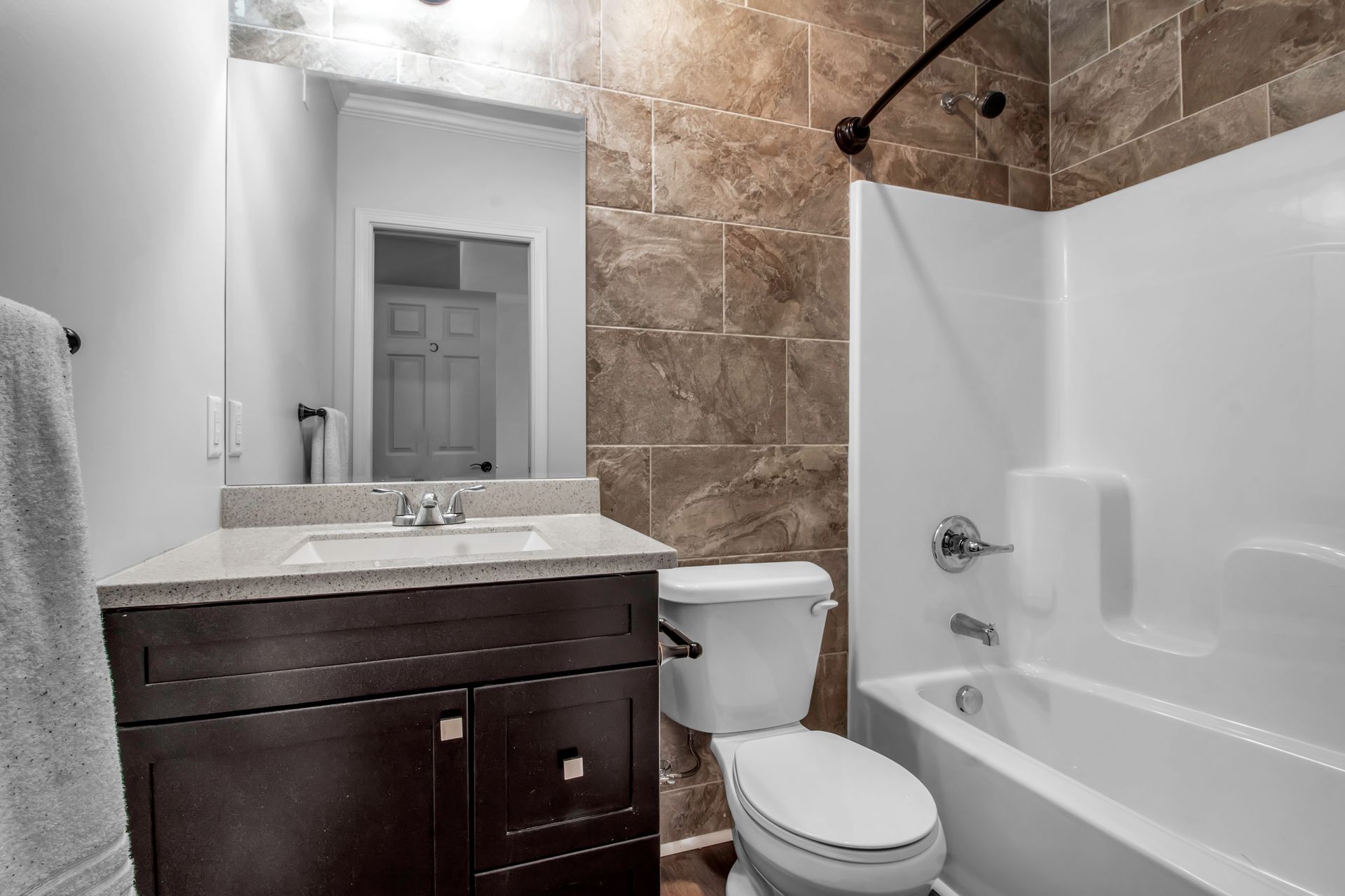 A bathroom with a toilet , sink , and bathtub.