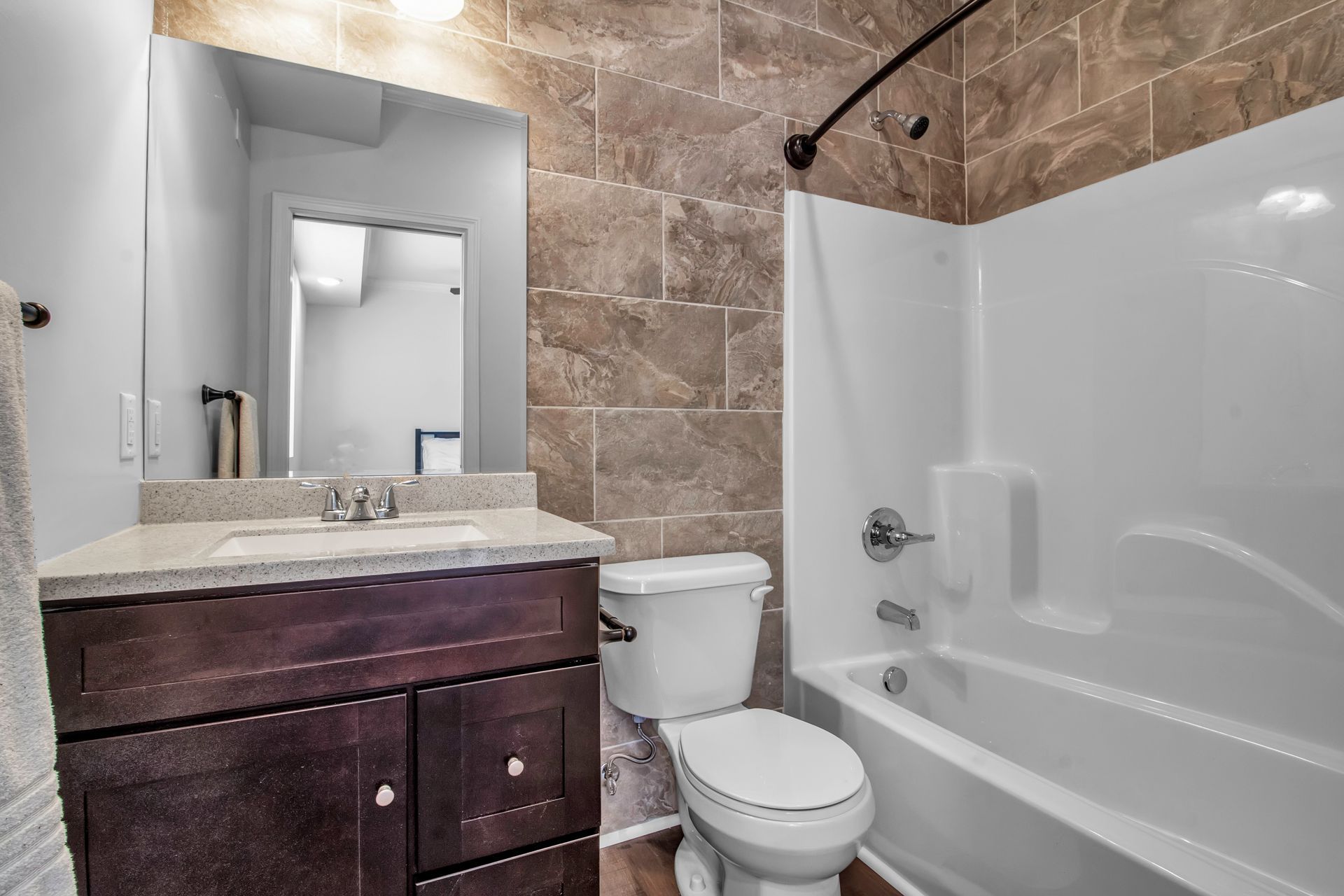 A bathroom with a toilet , sink , and bathtub.