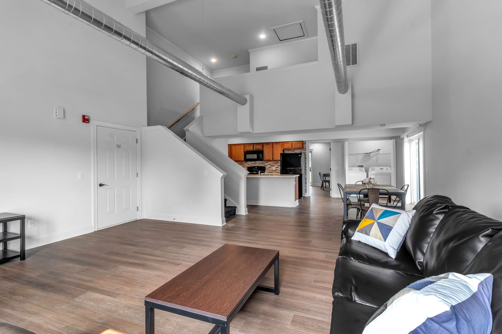 A living room with a black couch and a coffee table
