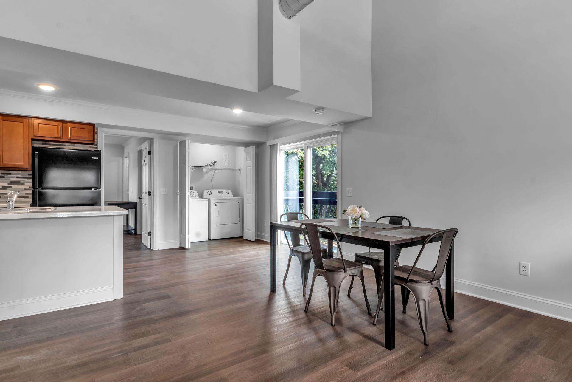 There is a dining table and chairs in the middle of the room.