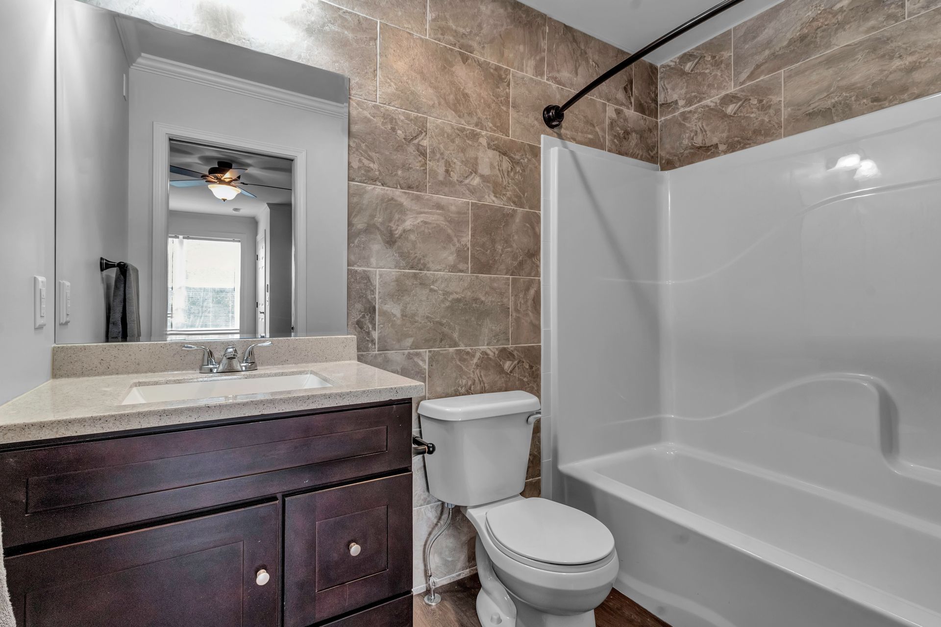 A bathroom with a toilet , sink , and bathtub.