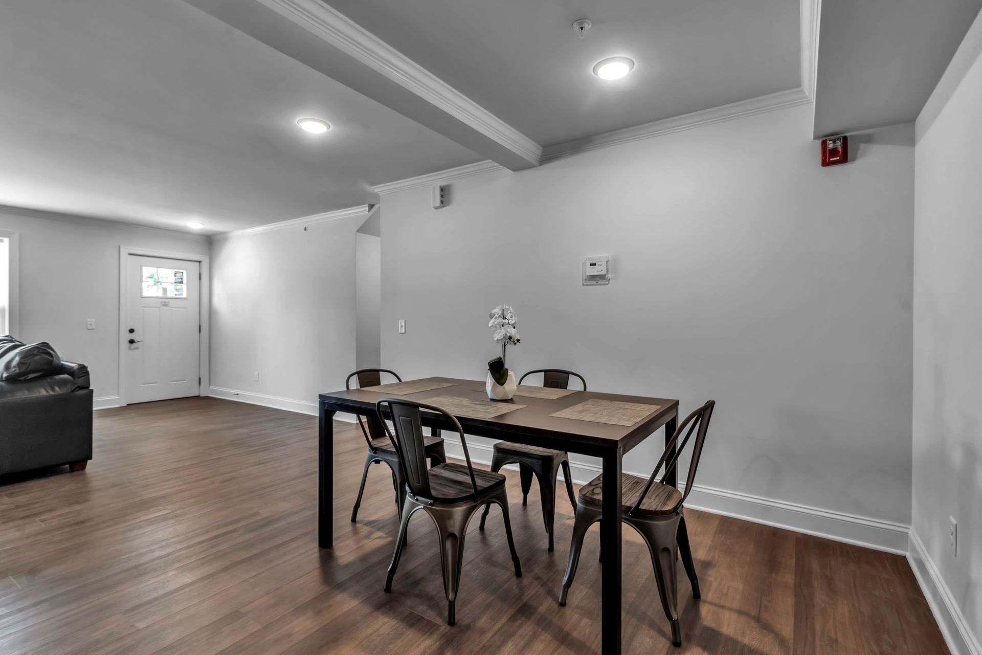 There is a dining table and chairs in the middle of the room.