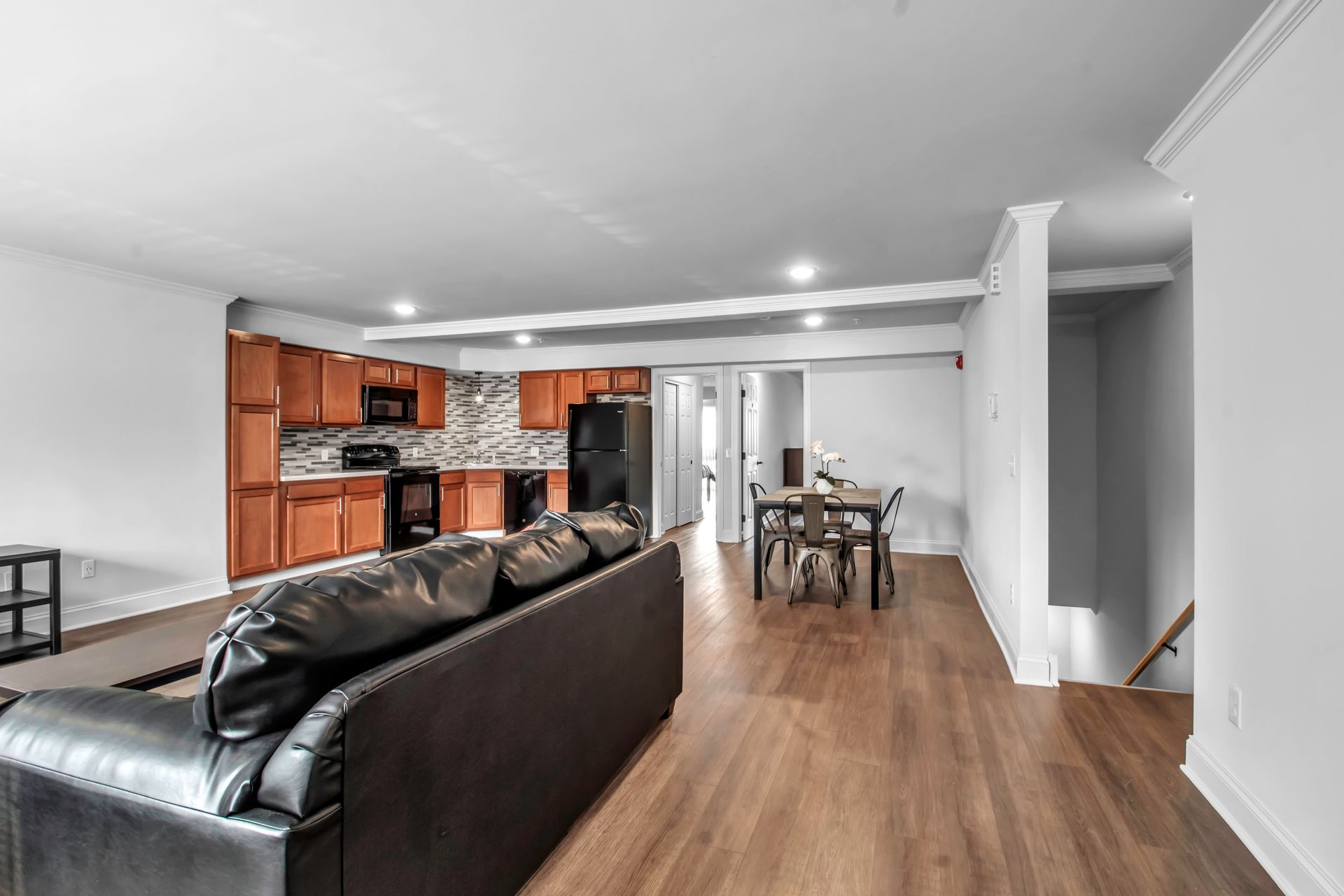 A living room with a couch , table and chairs in a basement.