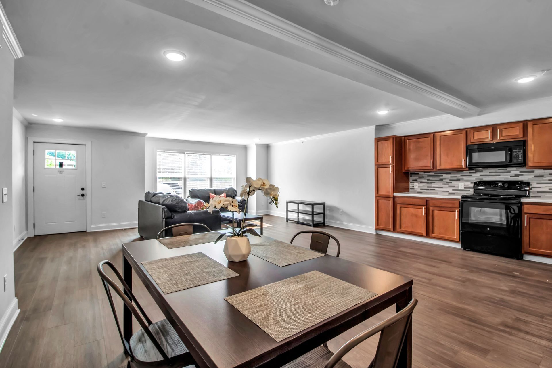 There is a dining table and chairs in the middle of the room.