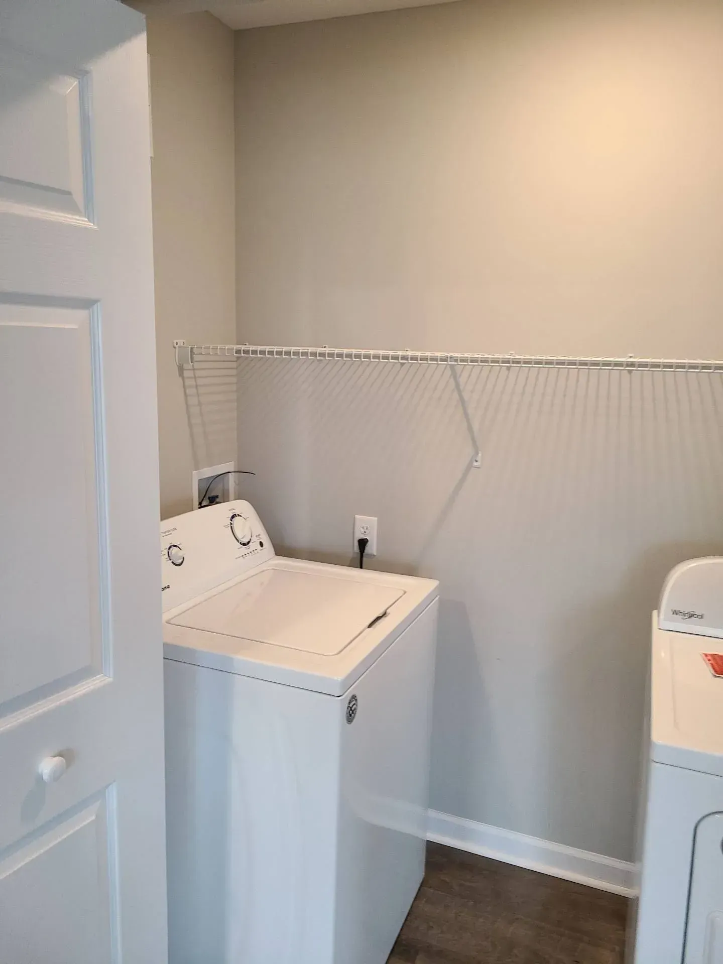 A laundry room with a washer and dryer in it.