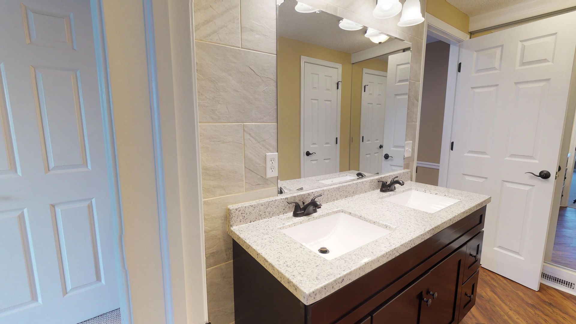 A bathroom with two sinks and a mirror.
