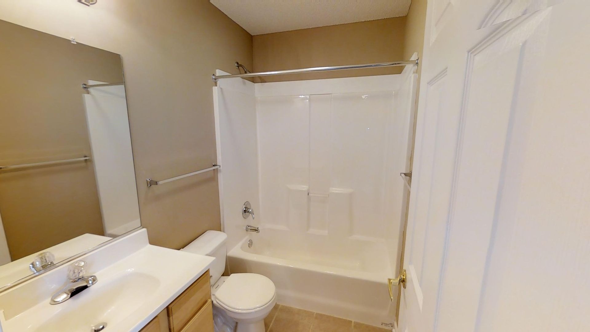 A bathroom with a sink , toilet , bathtub and mirror.