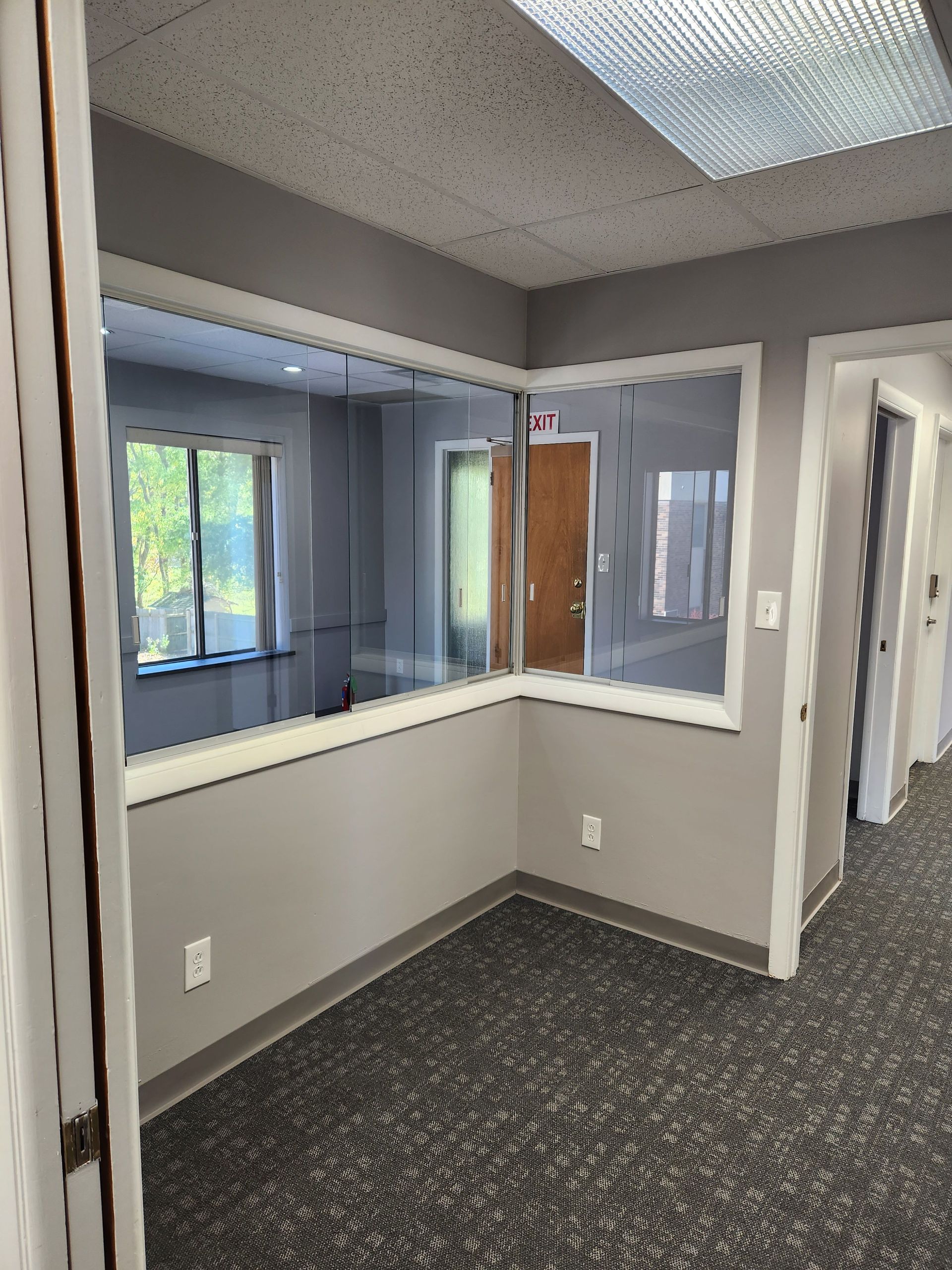 There is a large window in the corner of the room.