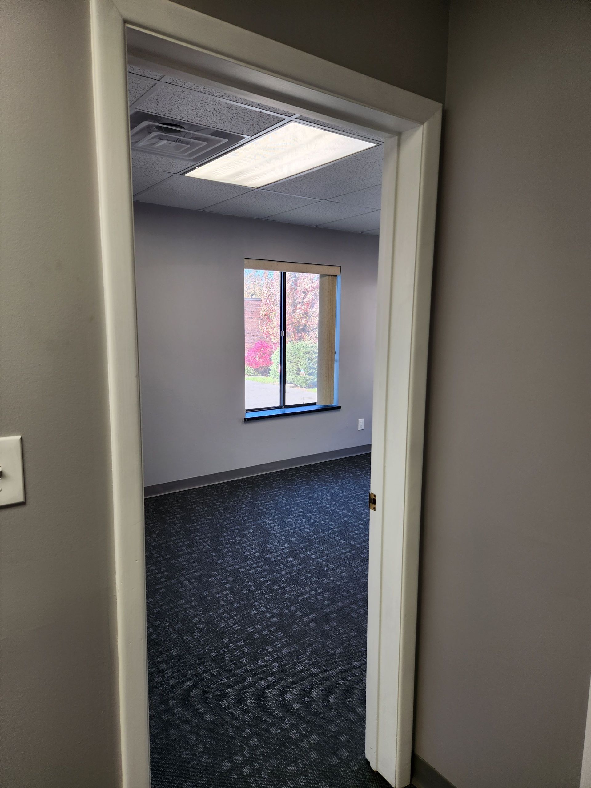 A doorway leading into an empty room with a window.