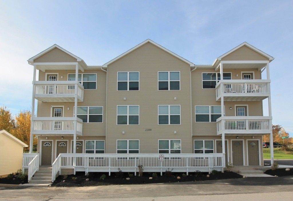 A large apartment building with lots of windows and balconies