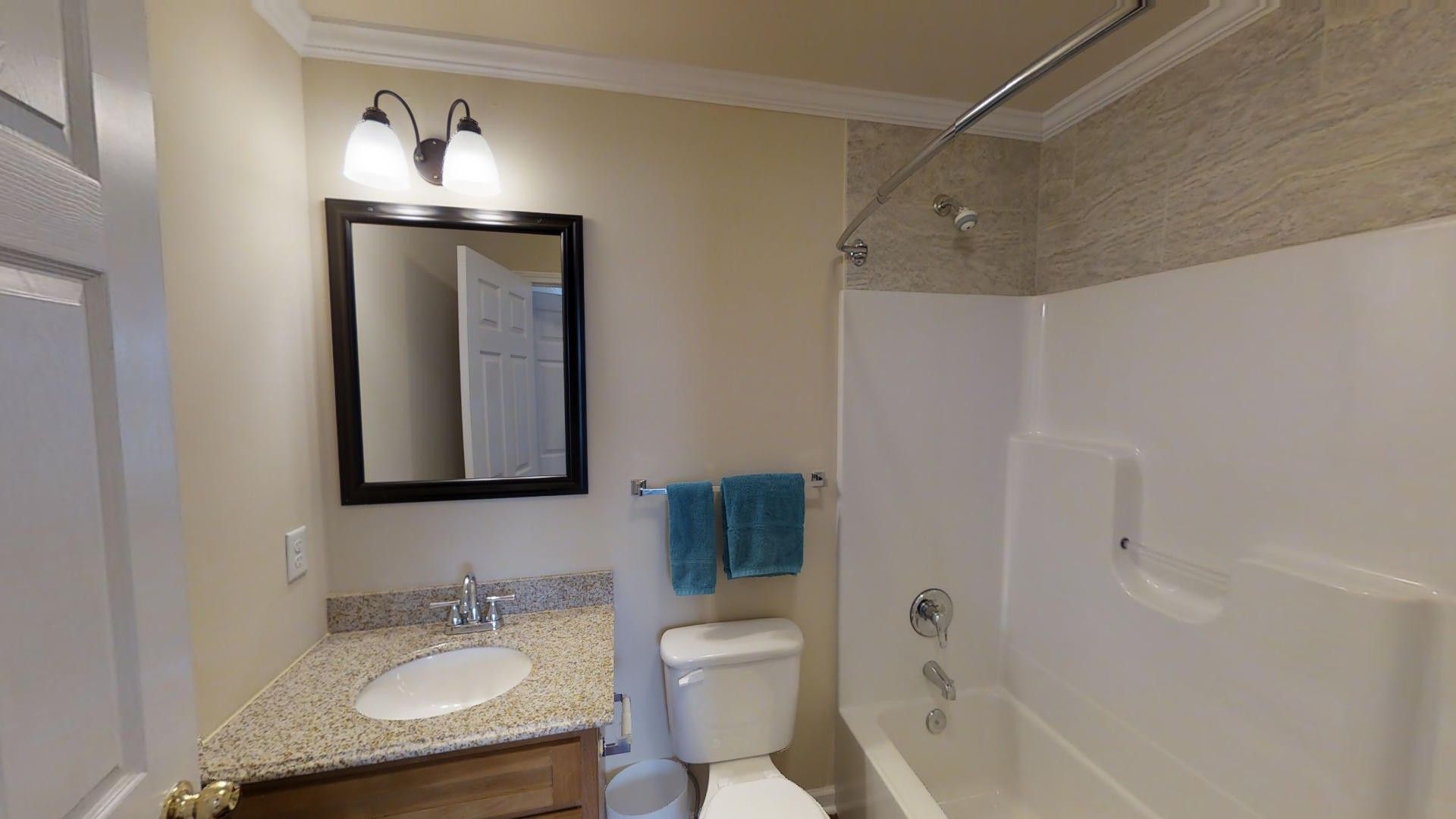 A bathroom with a toilet , sink , and bathtub.