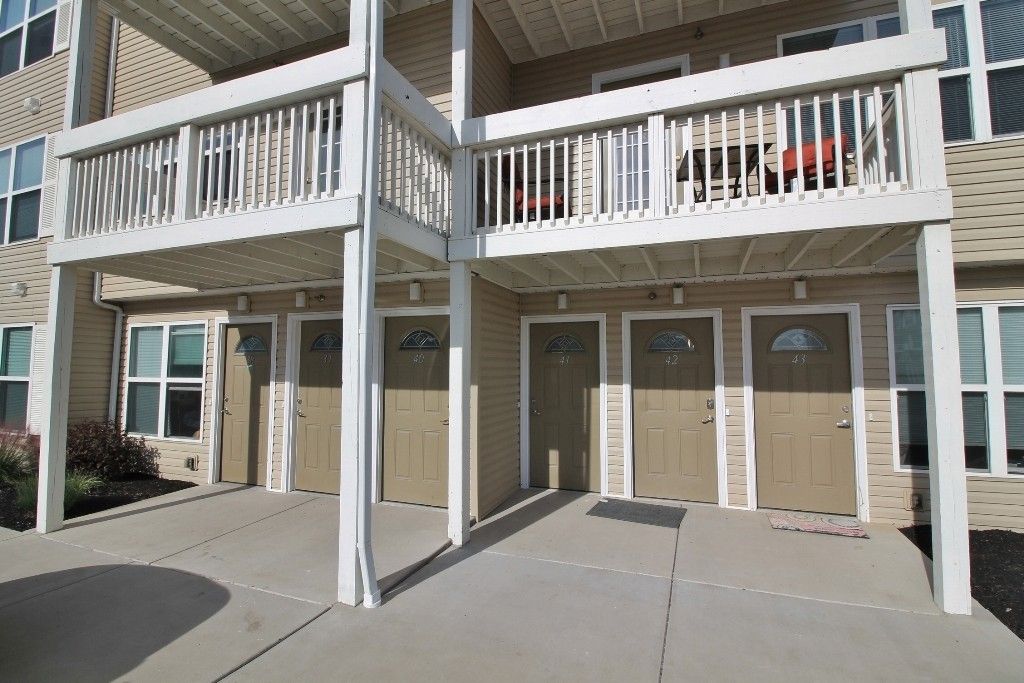 A building with a balcony and a ramp leading to it