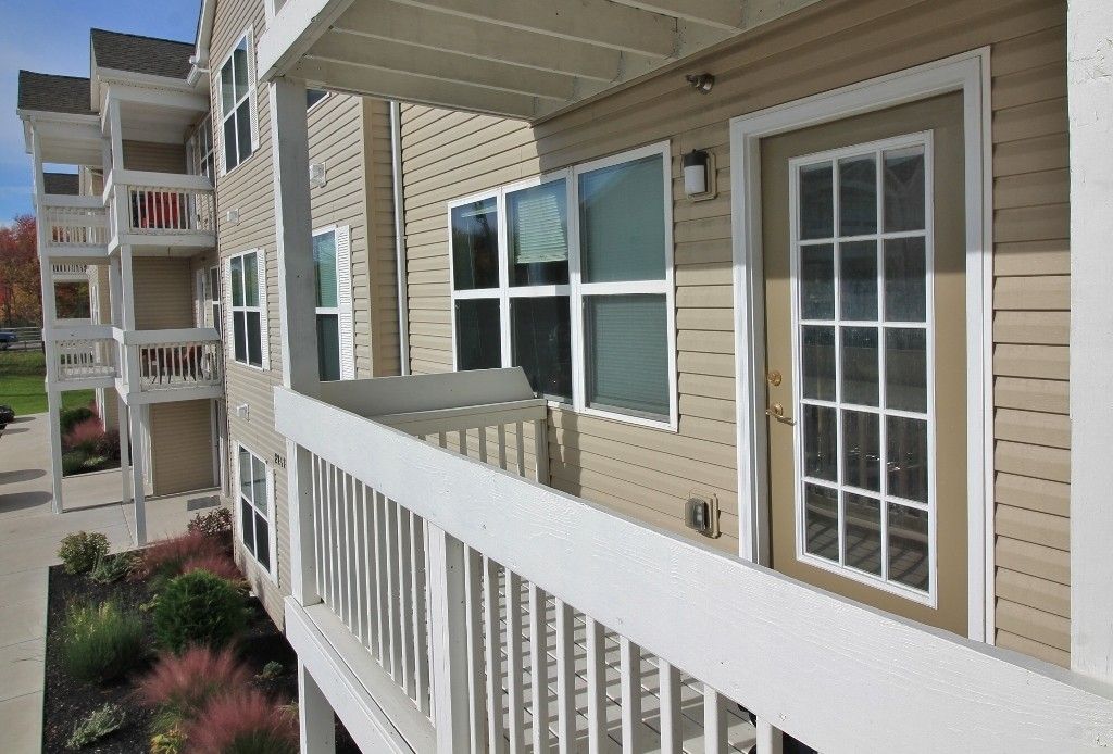 A building with a balcony and a white railing