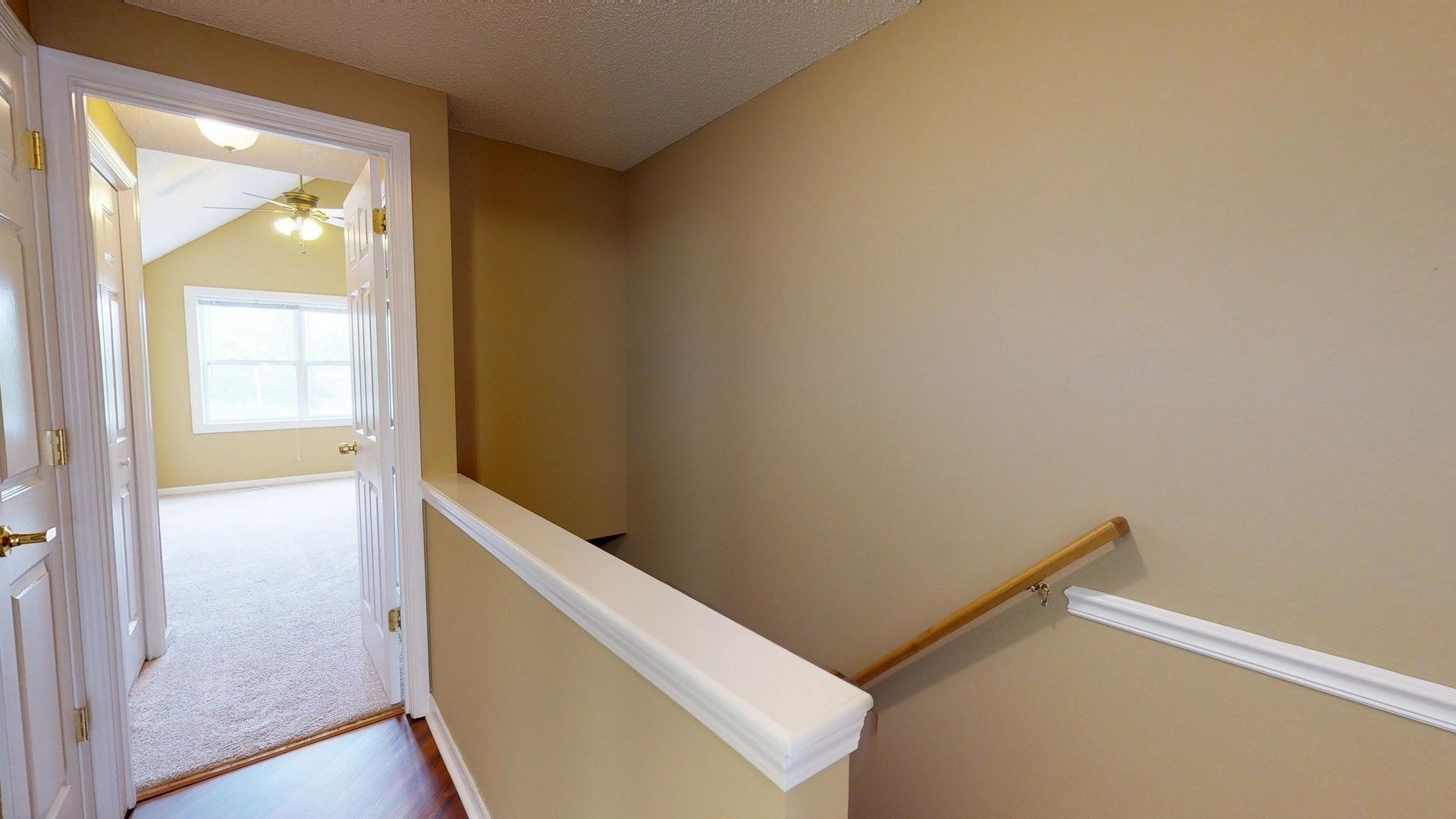 A staircase leading up to a bedroom in a house.